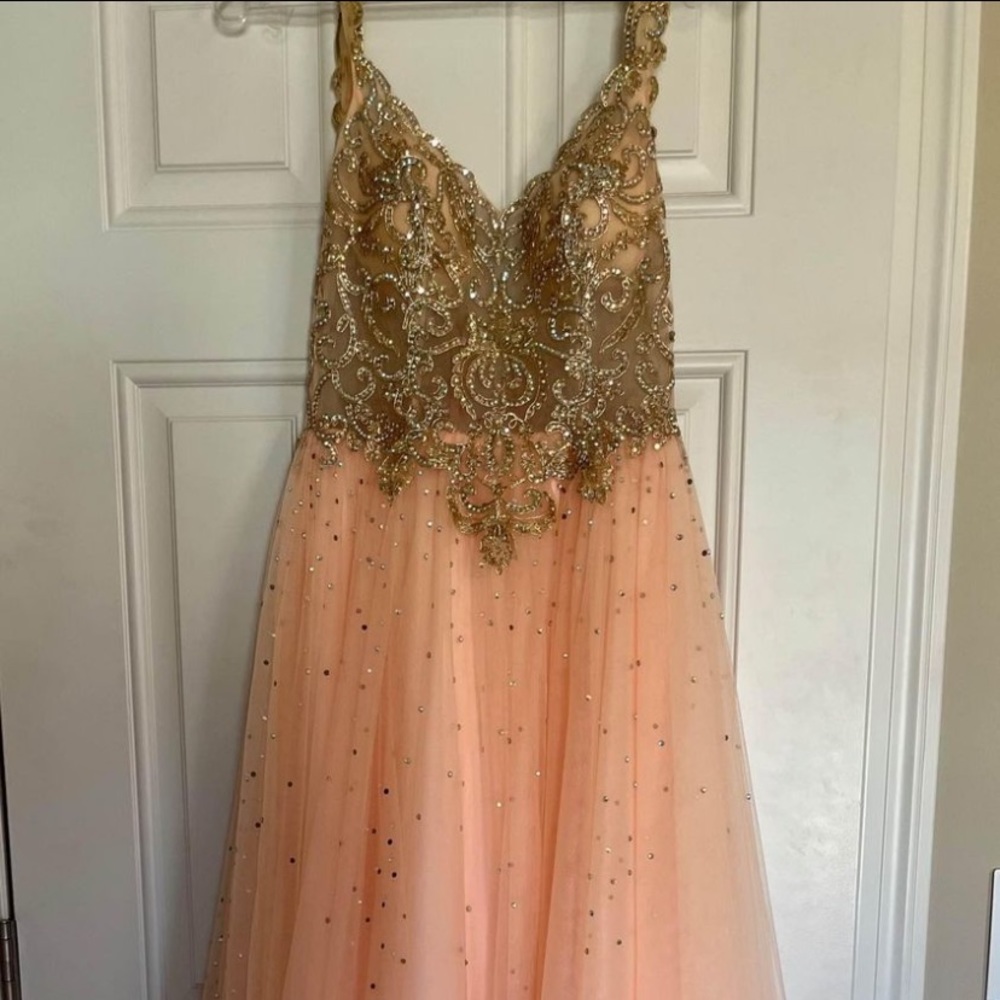 Homecoming/prom dress. It’s a soft peachy pink color the skirt part and the top.